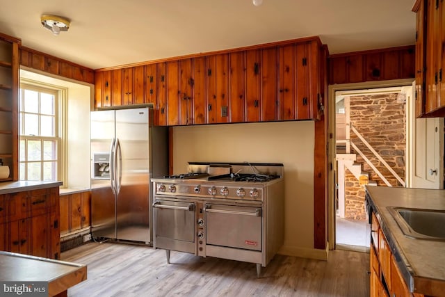 kitchen featuring appliances with stainless steel finishes, light hardwood / wood-style floors, and sink