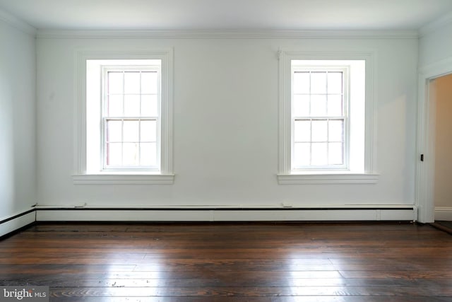 empty room with plenty of natural light, dark hardwood / wood-style flooring, and a baseboard heating unit