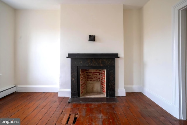 room details featuring baseboard heating and hardwood / wood-style flooring