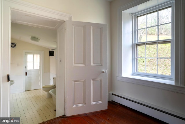 hall featuring a baseboard radiator and plenty of natural light