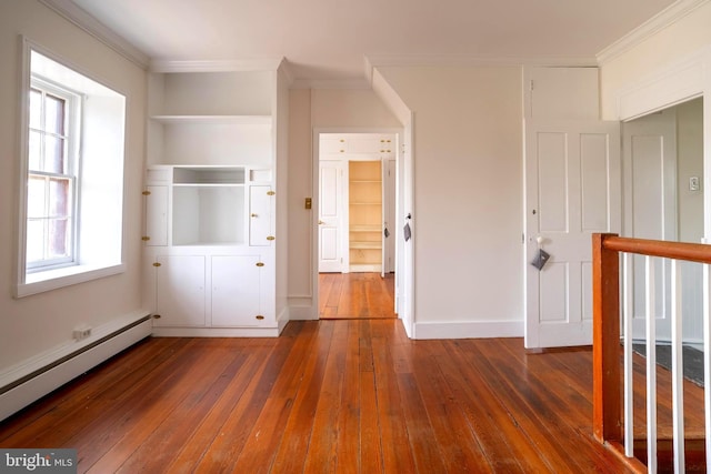 unfurnished bedroom featuring dark wood-type flooring, baseboard heating, and crown molding