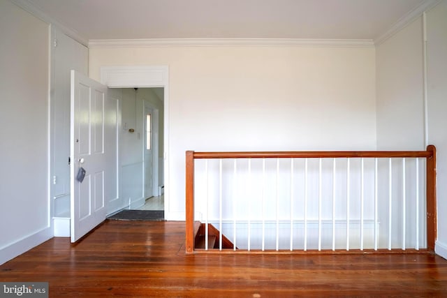 empty room featuring dark hardwood / wood-style floors and crown molding