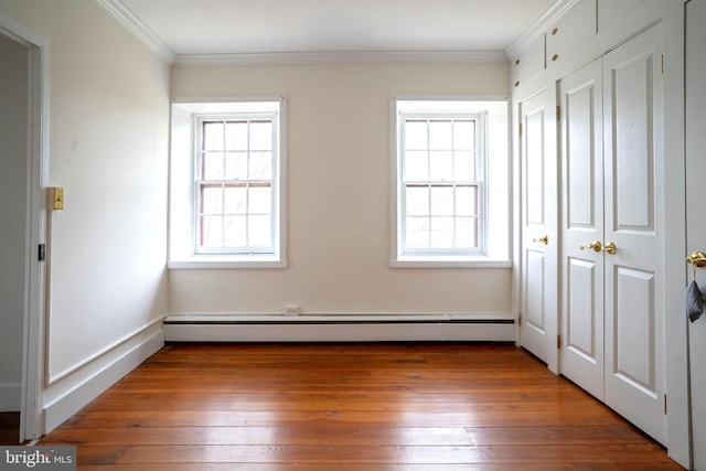 unfurnished bedroom with dark hardwood / wood-style flooring, crown molding, and a baseboard radiator