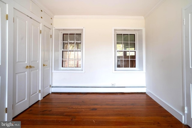 interior space with dark hardwood / wood-style floors, baseboard heating, and crown molding