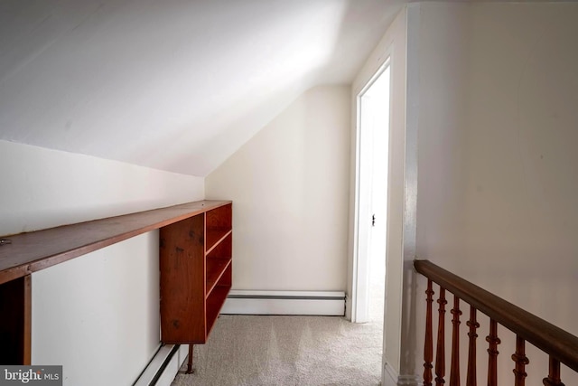 additional living space featuring light carpet, a baseboard radiator, and lofted ceiling