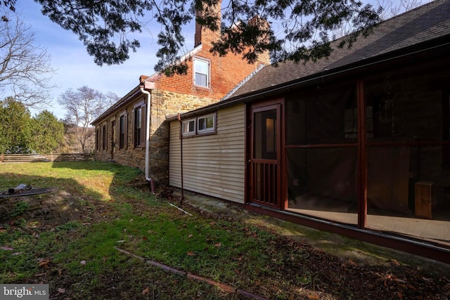 view of side of property with a lawn