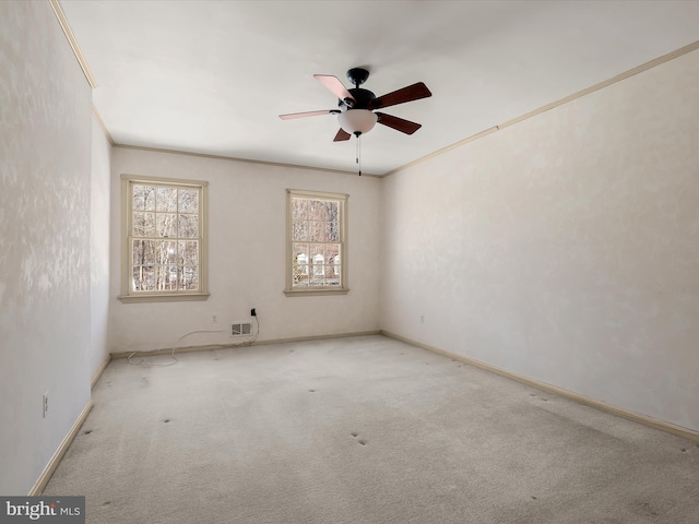 carpeted spare room with crown molding and ceiling fan