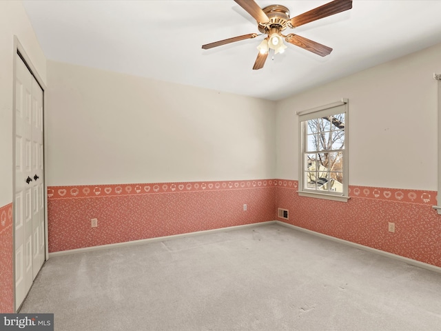 empty room with light carpet and ceiling fan