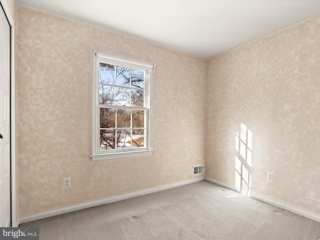 empty room featuring light colored carpet