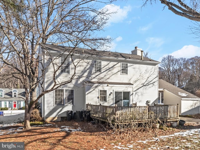 rear view of property featuring a deck