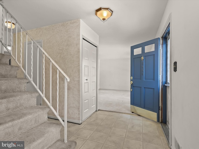 view of carpeted entrance foyer