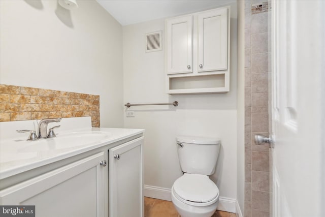 bathroom featuring toilet and vanity