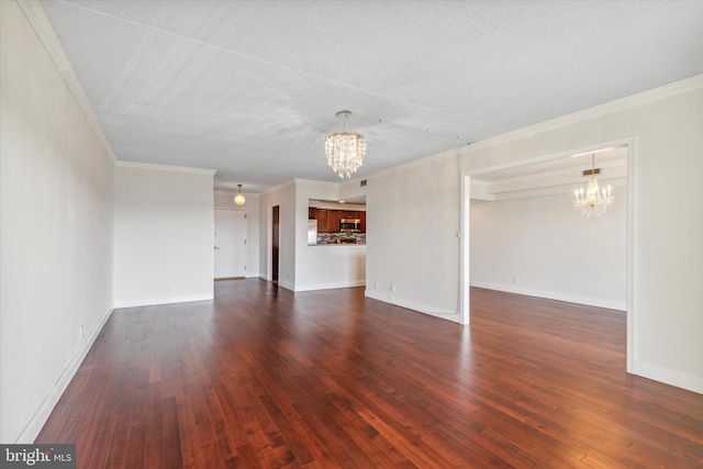 unfurnished living room featuring ornamental molding, a notable chandelier, and dark hardwood / wood-style floors