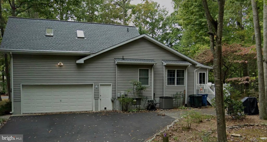 back of property featuring a garage