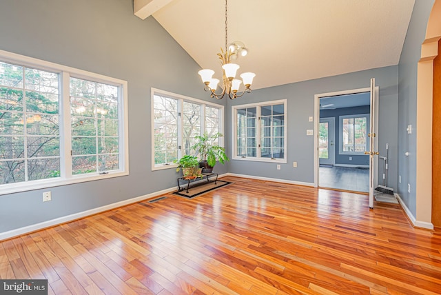 unfurnished dining area featuring a chandelier, beamed ceiling, high vaulted ceiling, and light hardwood / wood-style floors