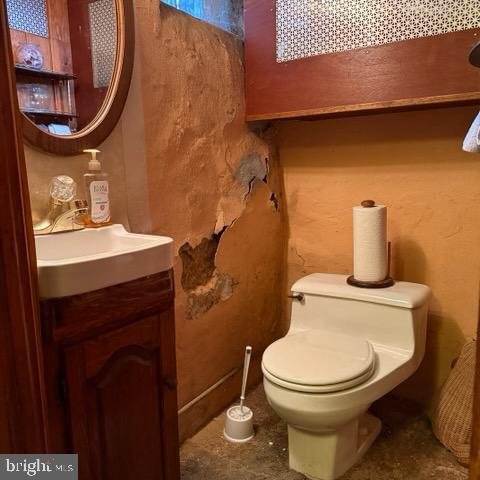 half bathroom with toilet and vanity