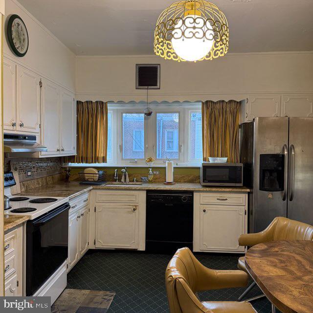 kitchen with under cabinet range hood, a sink, visible vents, white cabinetry, and appliances with stainless steel finishes