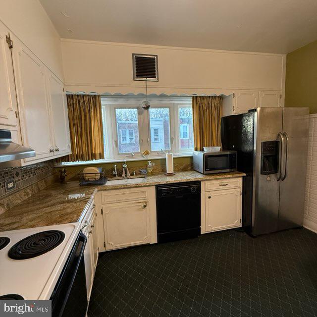 kitchen featuring visible vents, white cabinets, appliances with stainless steel finishes, under cabinet range hood, and a sink