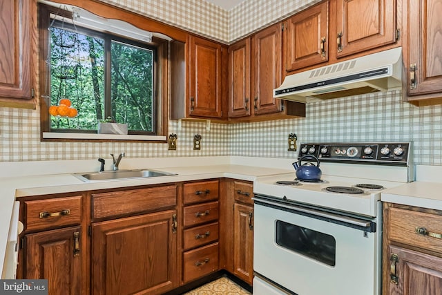 kitchen featuring white electric range oven, decorative backsplash, and sink