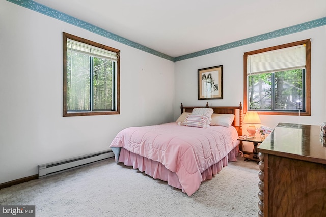 bedroom featuring carpet and a baseboard heating unit