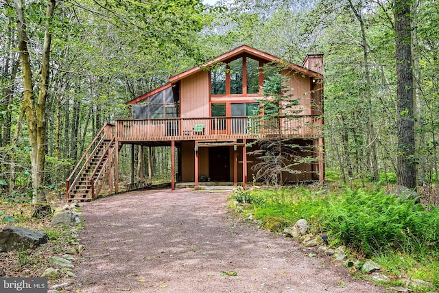 front facade with a wooden deck