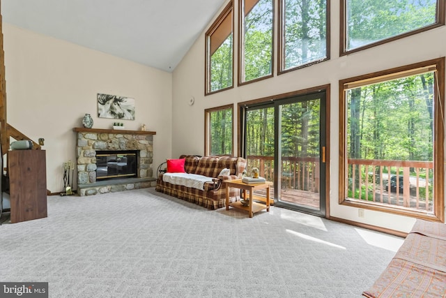 living room featuring carpet flooring, a fireplace, and high vaulted ceiling