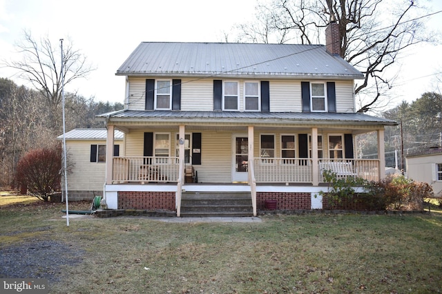 farmhouse with a porch, a front yard, metal roof, and a chimney