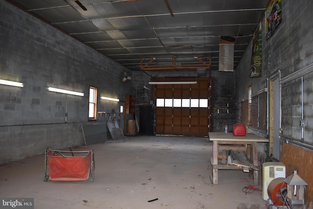 interior space featuring a garage and unfinished concrete flooring