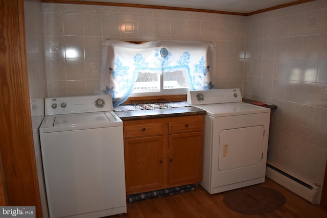 laundry area featuring light wood finished floors, washer / clothes dryer, baseboard heating, and tile walls