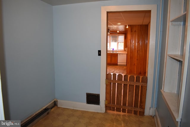 interior space with a paneled ceiling, visible vents, baseboards, and tile patterned floors