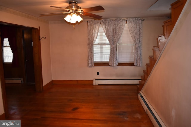 foyer entrance featuring stairway, a baseboard heating unit, and dark wood-style flooring