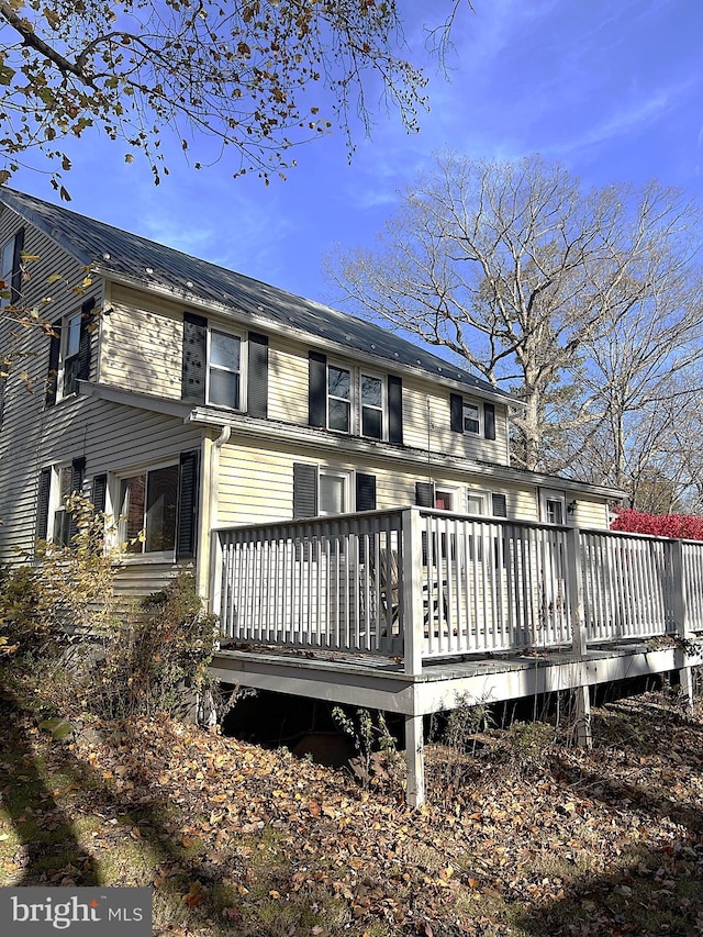 back of house featuring a deck