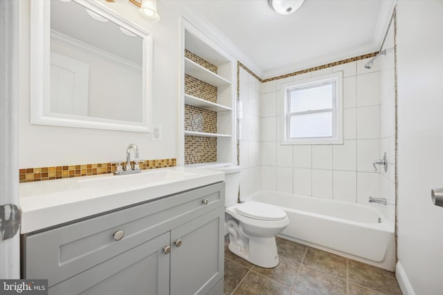 full bathroom featuring vanity, tile patterned floors, crown molding, tiled shower / bath combo, and toilet