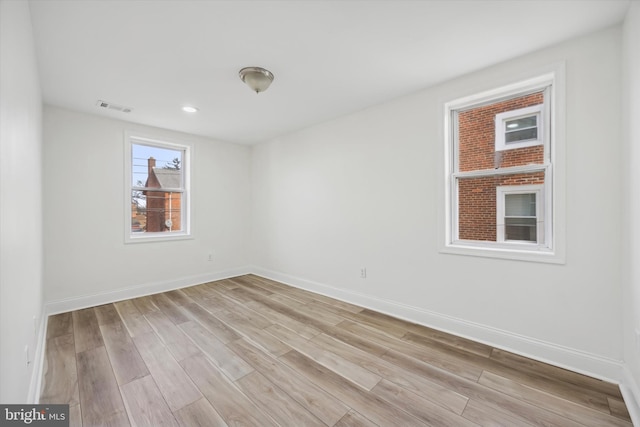 spare room featuring light wood-type flooring