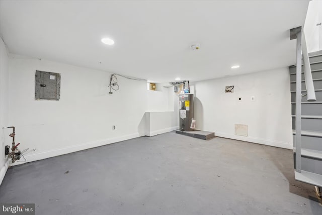 basement featuring electric water heater and electric panel