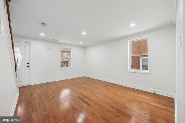 unfurnished room featuring hardwood / wood-style floors and ornamental molding