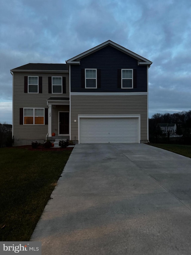 view of front facade featuring a front yard and a garage