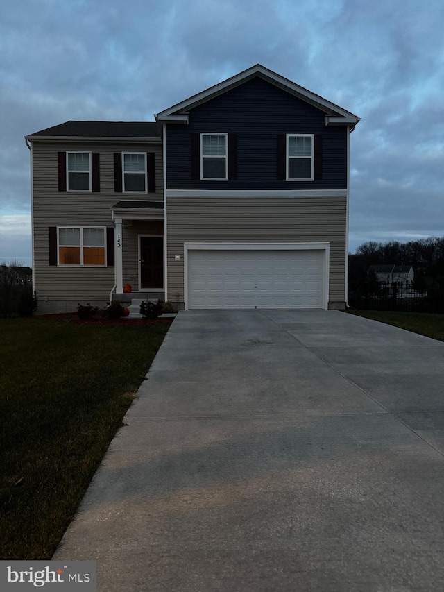 view of front of property featuring a garage and a front lawn