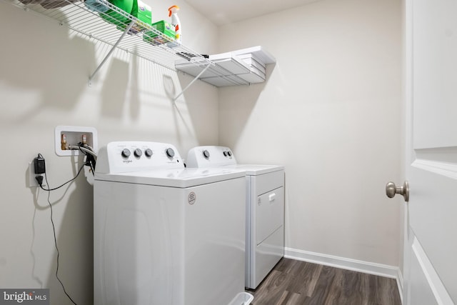 laundry area with dark hardwood / wood-style floors and separate washer and dryer