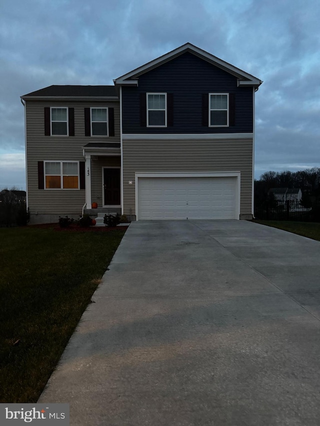 view of front of house with a front lawn and a garage