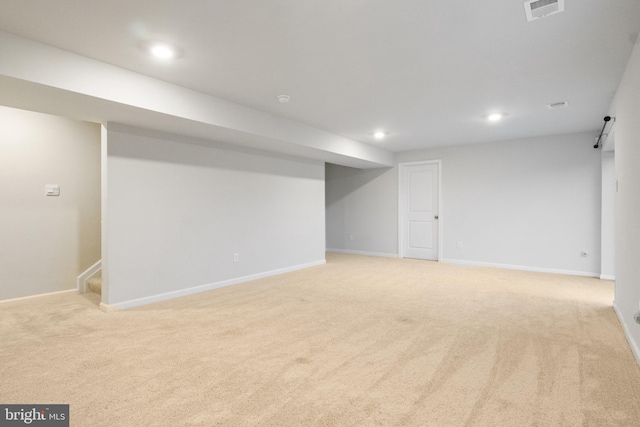 basement featuring light colored carpet