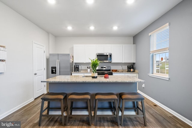 143 Knobby Hook, Hanover, PA 17331 - kitchen featuring appliances with stainless steel finishes, a kitchen bar, baseboards, dark wood finished floors, and recessed lighting
