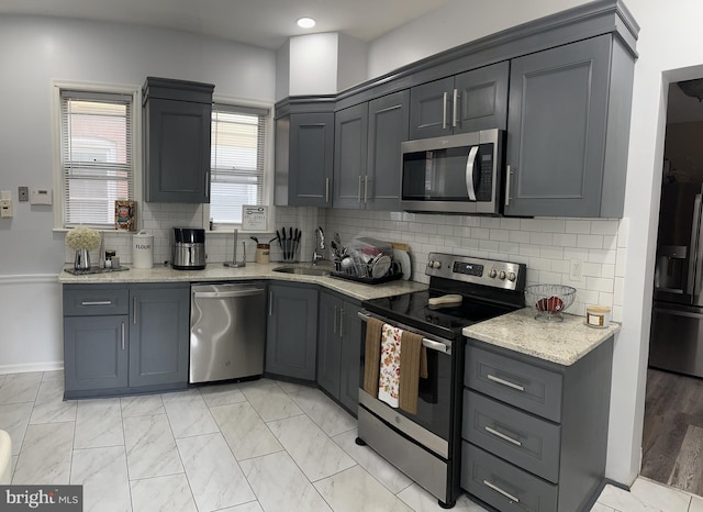 kitchen featuring appliances with stainless steel finishes and gray cabinetry