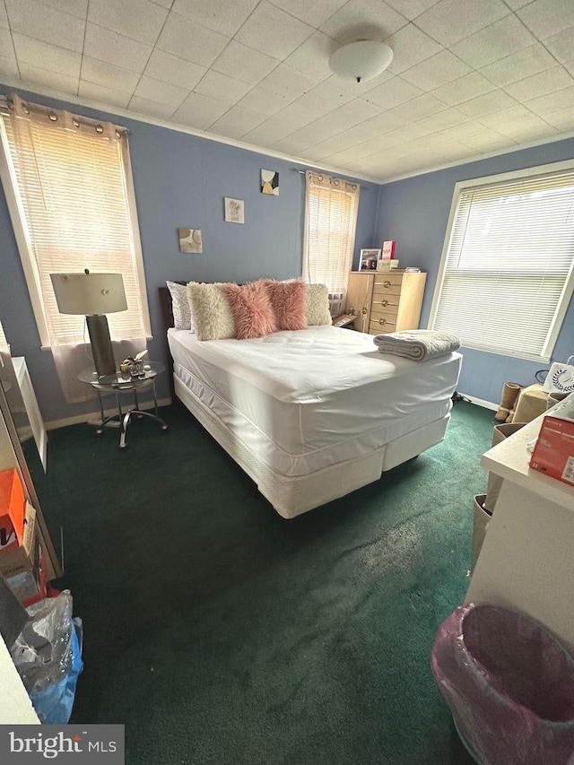 carpeted bedroom featuring crown molding