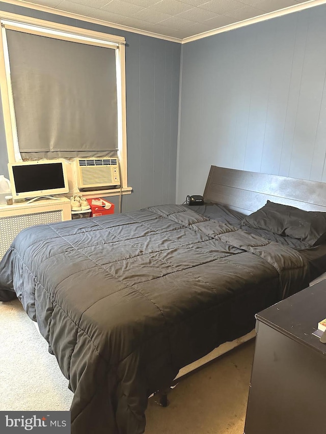 bedroom featuring cooling unit, carpet floors, and ornamental molding