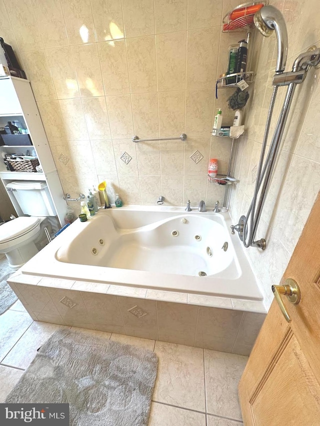 bathroom featuring tile patterned floors, tiled shower / bath, tile walls, and toilet