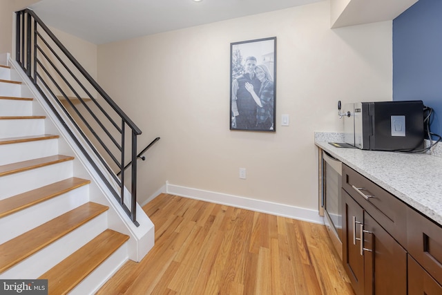 938 N Marshall St Unit 3, Philadelphia, PA 19123 - bar area featuring light wood finished floors, baseboards, and stairs