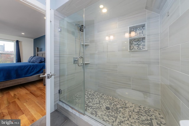 bathroom featuring hardwood / wood-style flooring and an enclosed shower