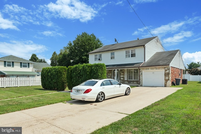 front of property with a garage and a front lawn