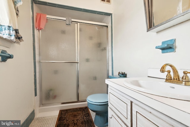 bathroom with tile patterned floors, vanity, toilet, and walk in shower